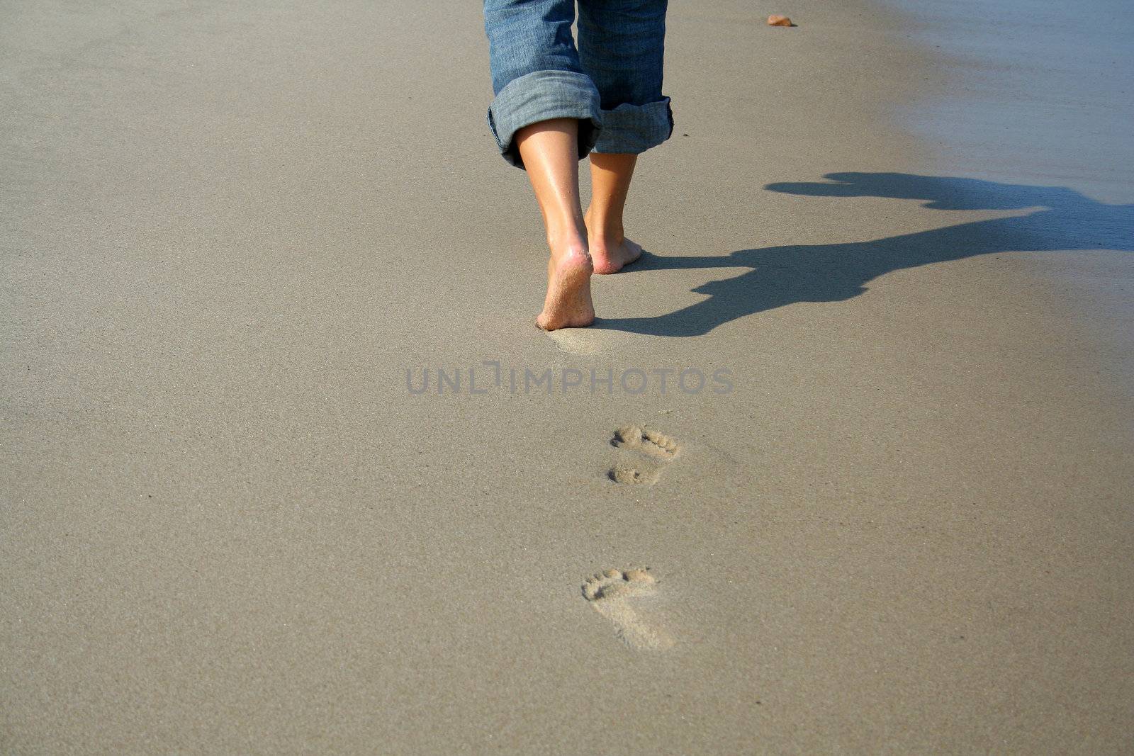 lonely woman walking on the beach