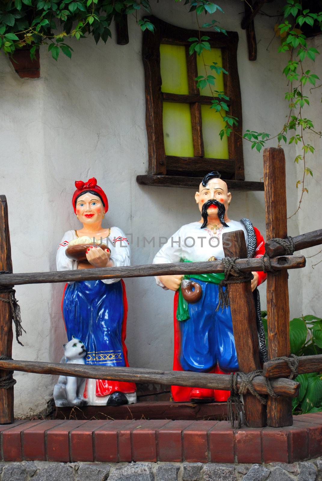 Ukrainian cossacks couple dolls near traditional ukrainian house