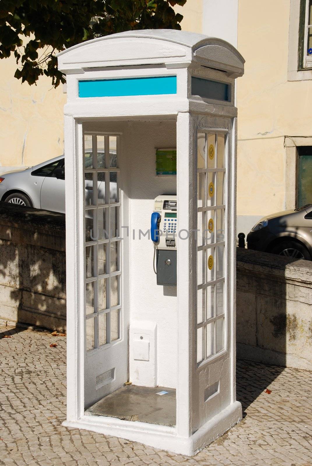 typical white telephone booth in Lisbon, Portugal