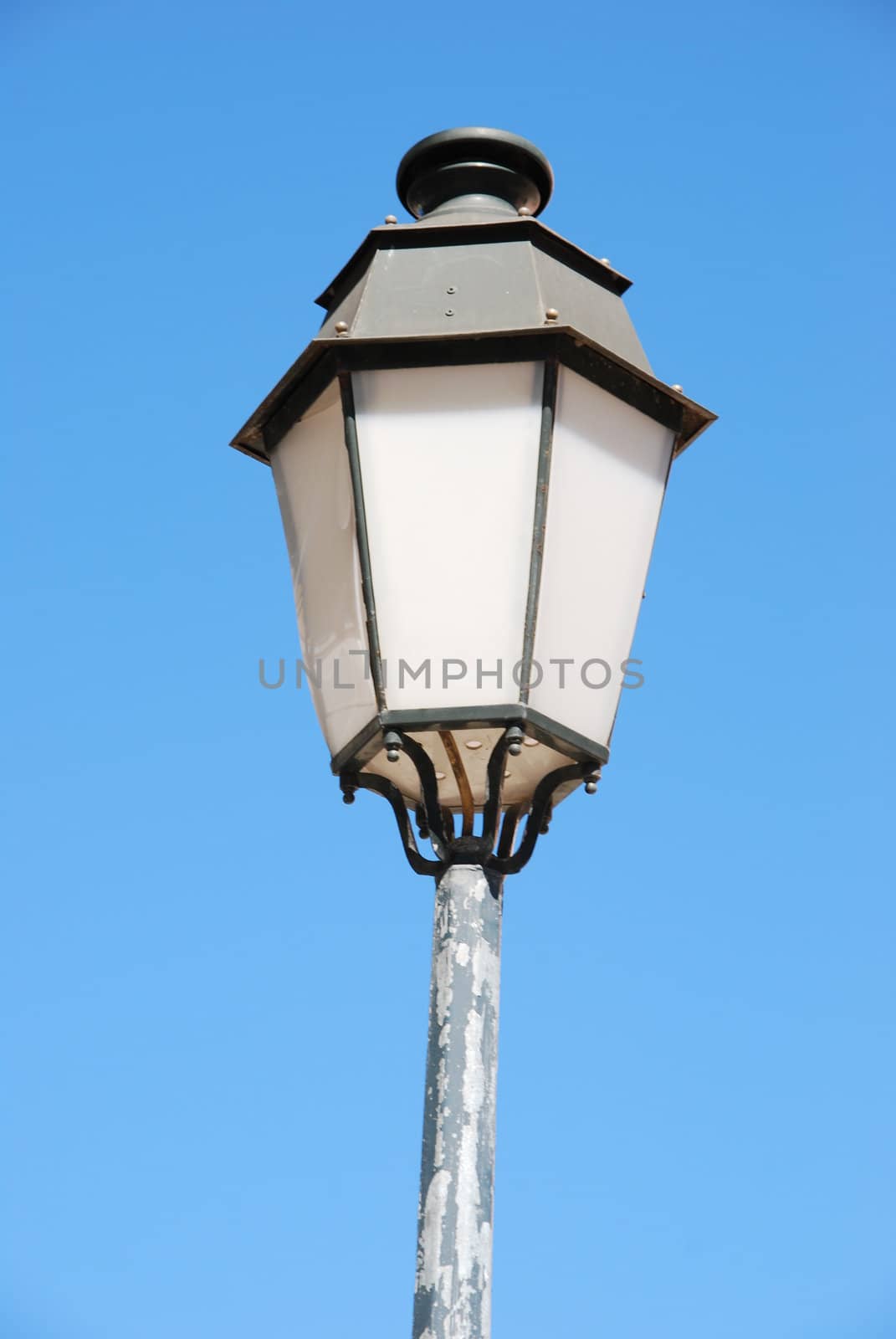 vintage lamp post against blue sky background