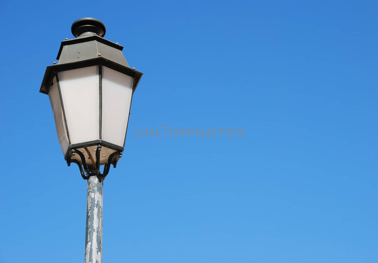 vintage lamp post against blue sky background