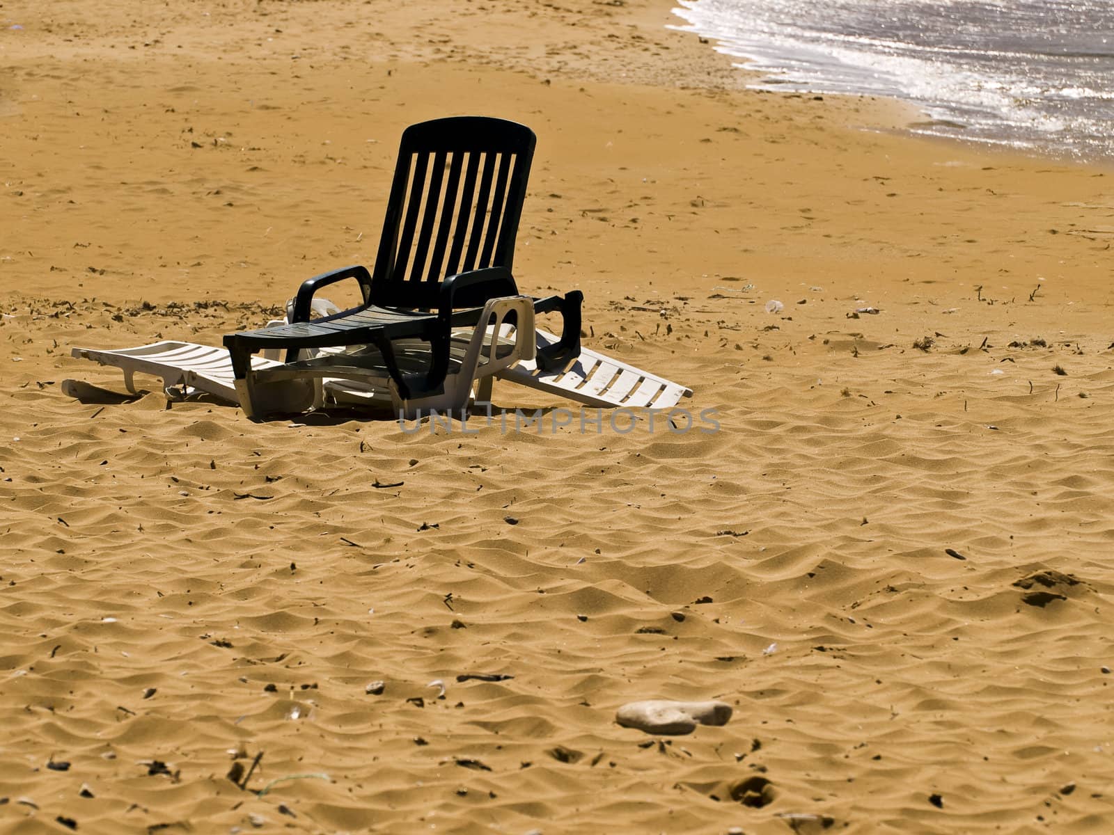 Lone chair on beautiful Mediterranean beach on the island of Malta