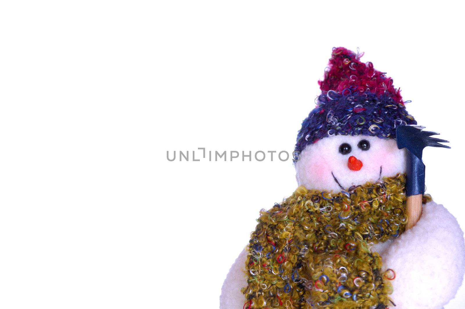 A snowman doll, holding a rake, isolated on a white background. Space for text.