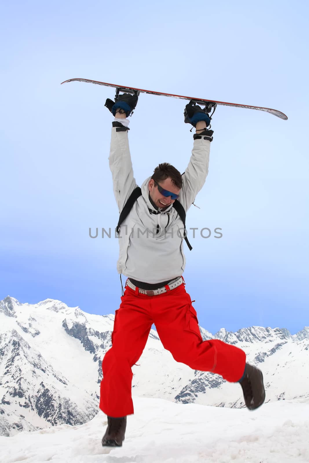 Men jumps with snowboard in two hands