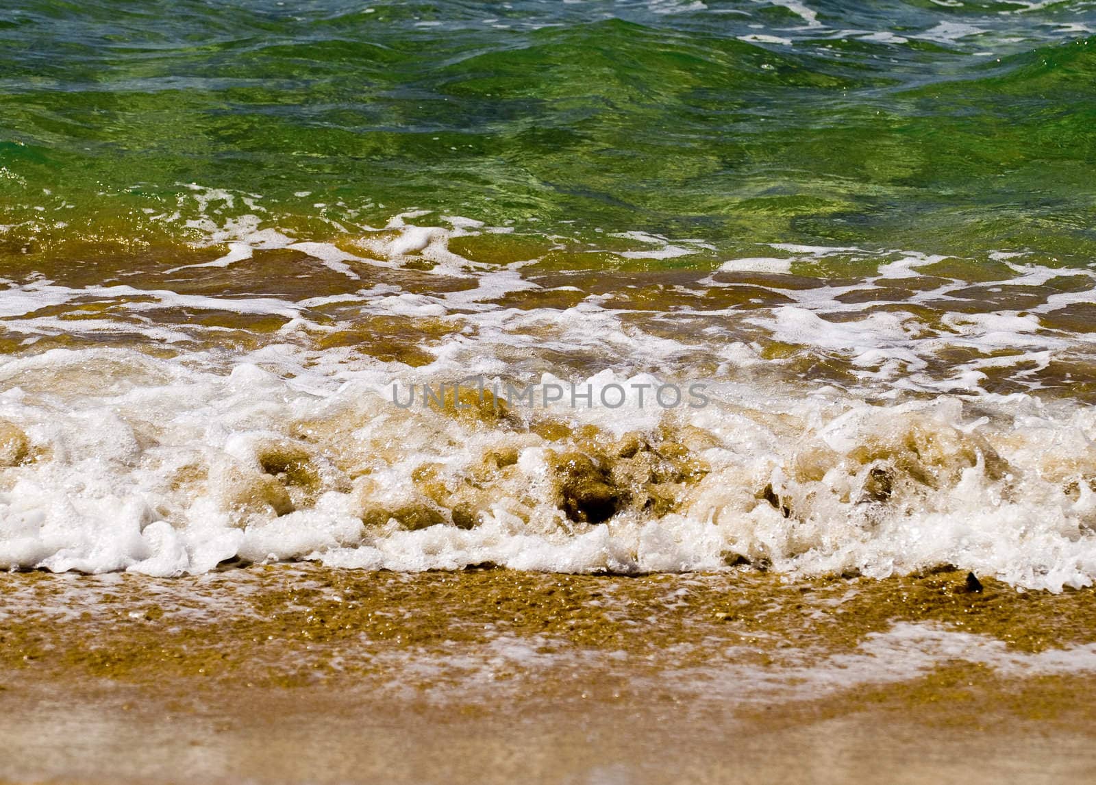 Waves crashing on the coast on a beach in Malta