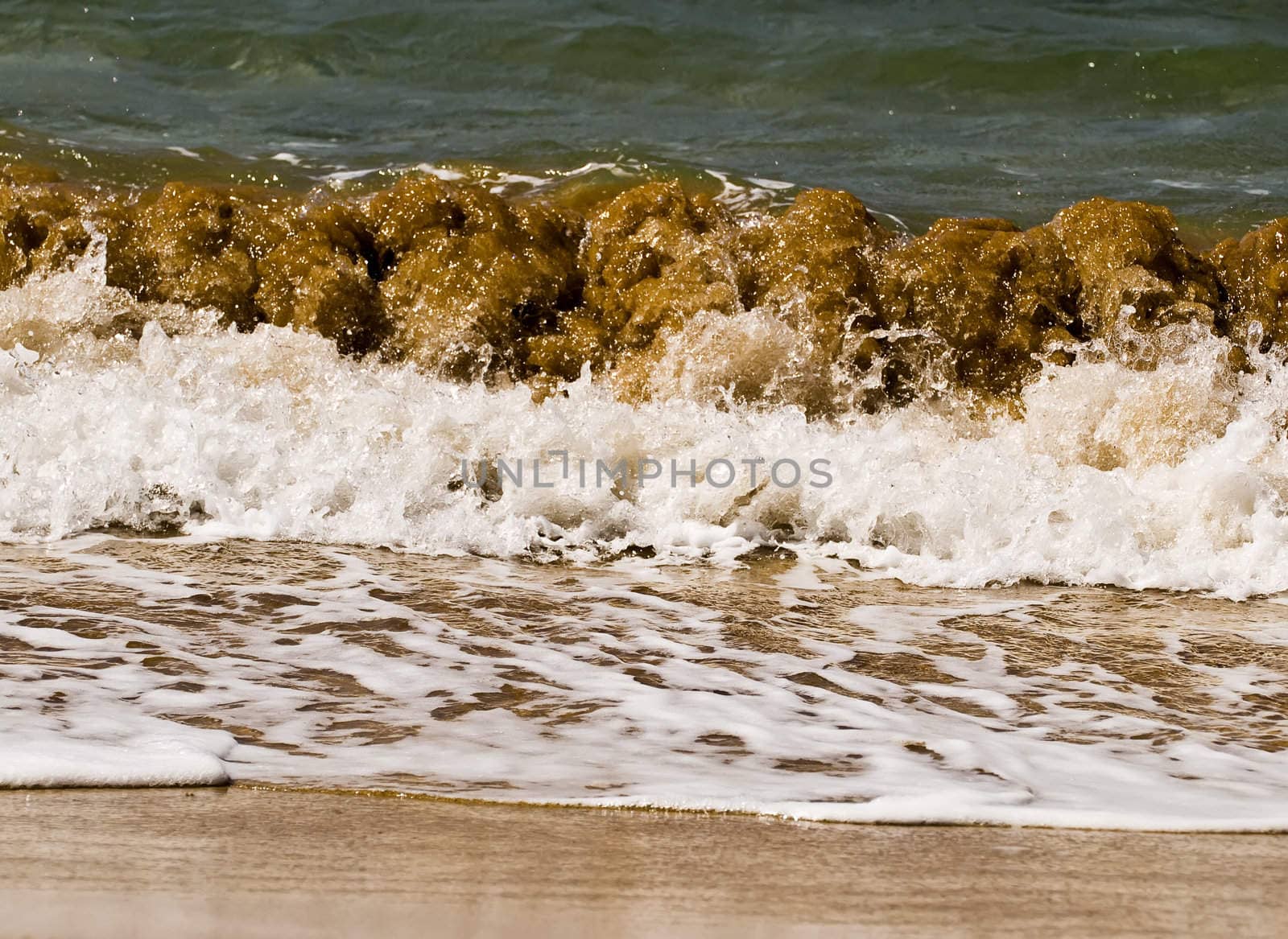 Waves crashing on the coast on a beach in Malta