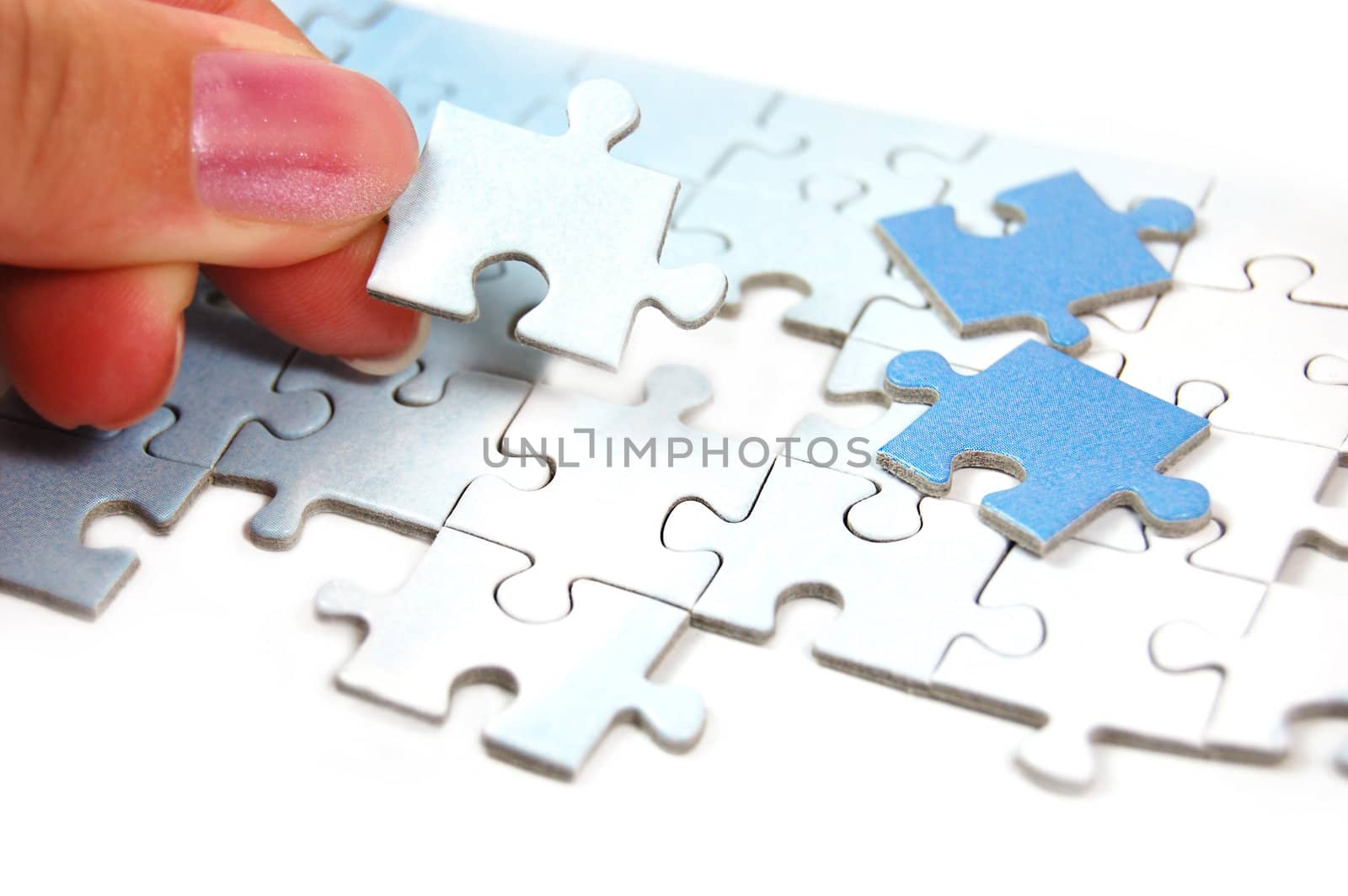 woman hand putting right piece in puzzle