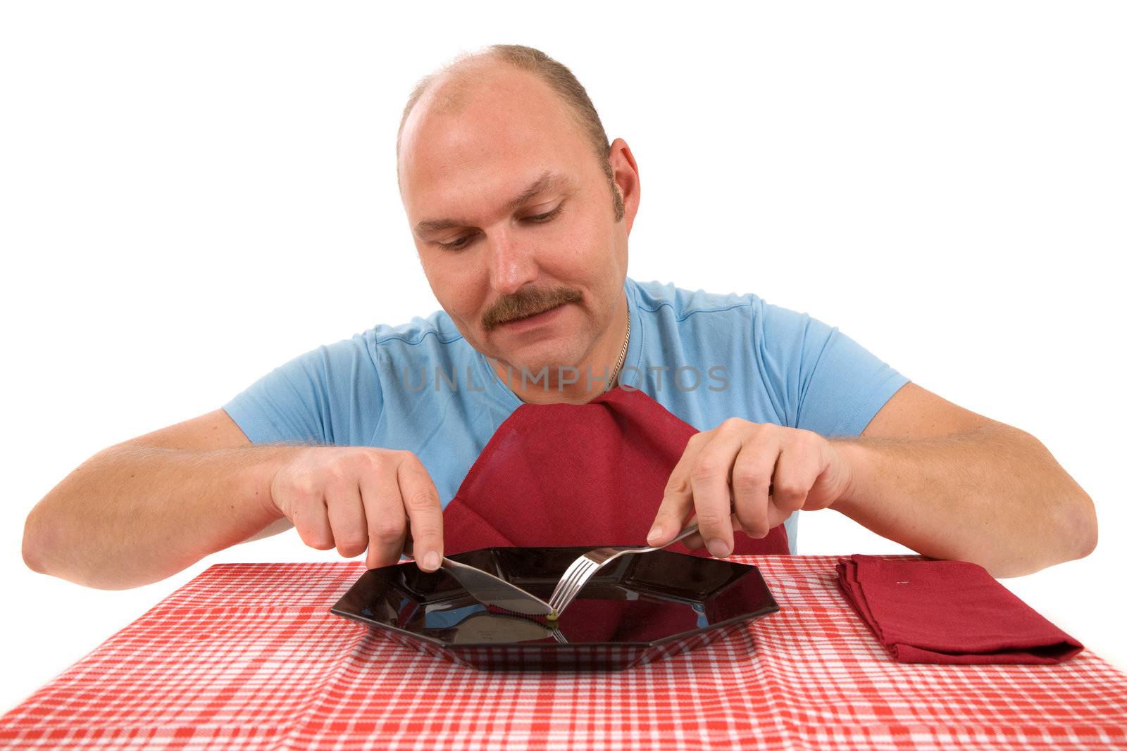 Mature man sitting in front of a plate with only a green pea