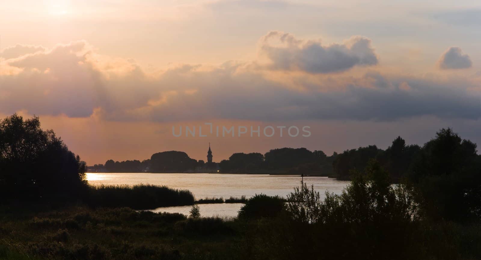 Summer evening light over Dutch river landscape