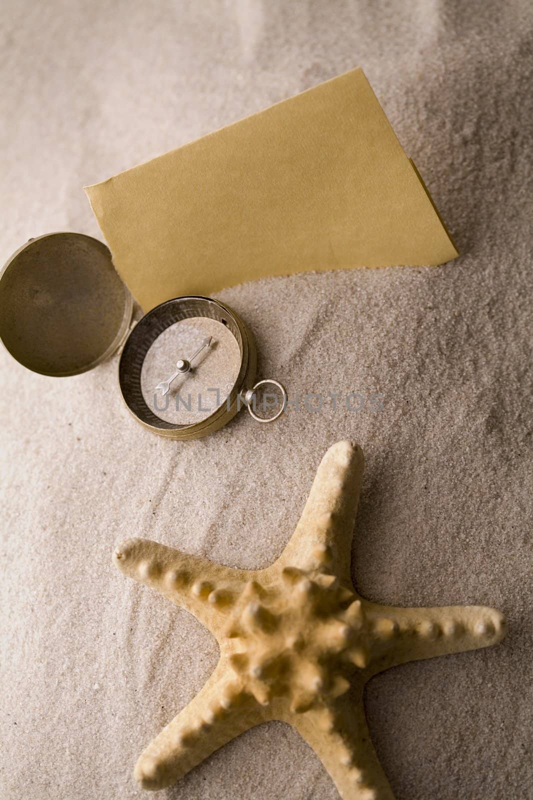 Compass on sand by shiffti