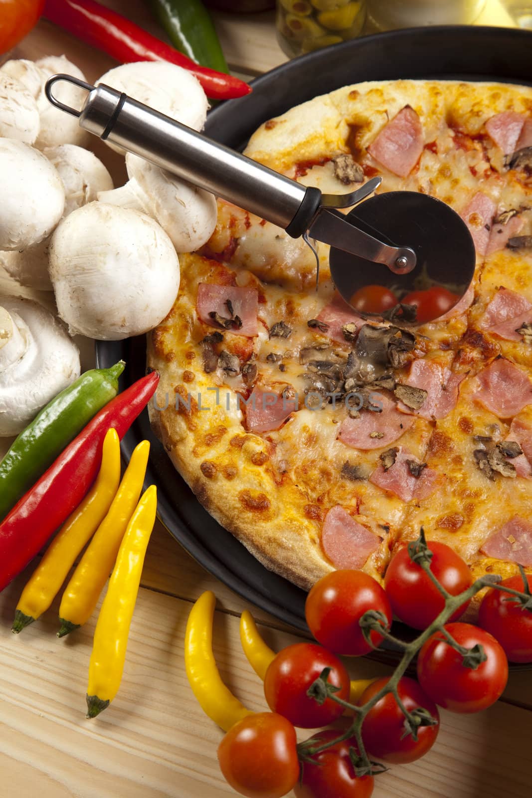 A couple of delicious pizzas, with raw tomatoes, green peppers and salami