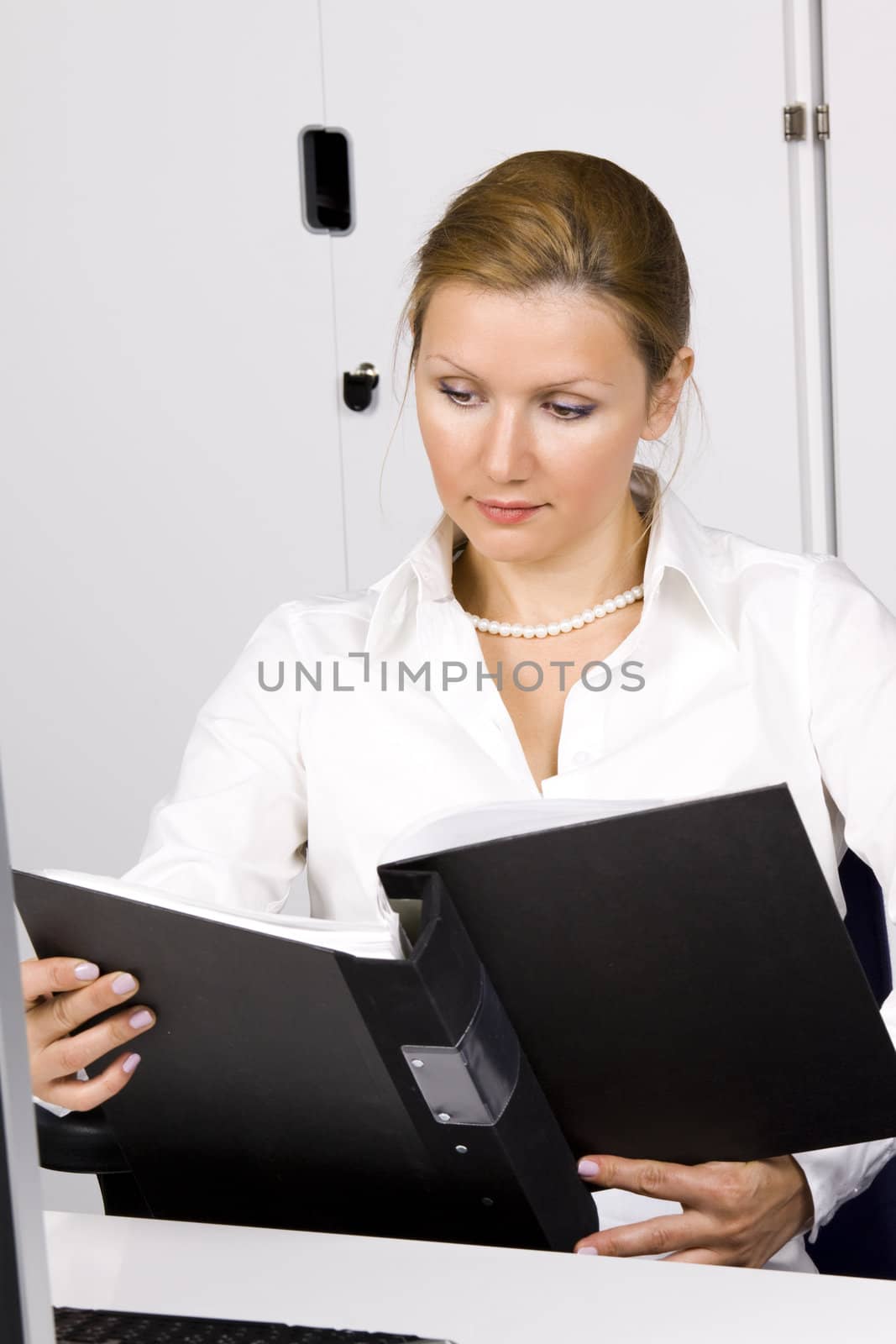 beautiful young woman at the office working with documents