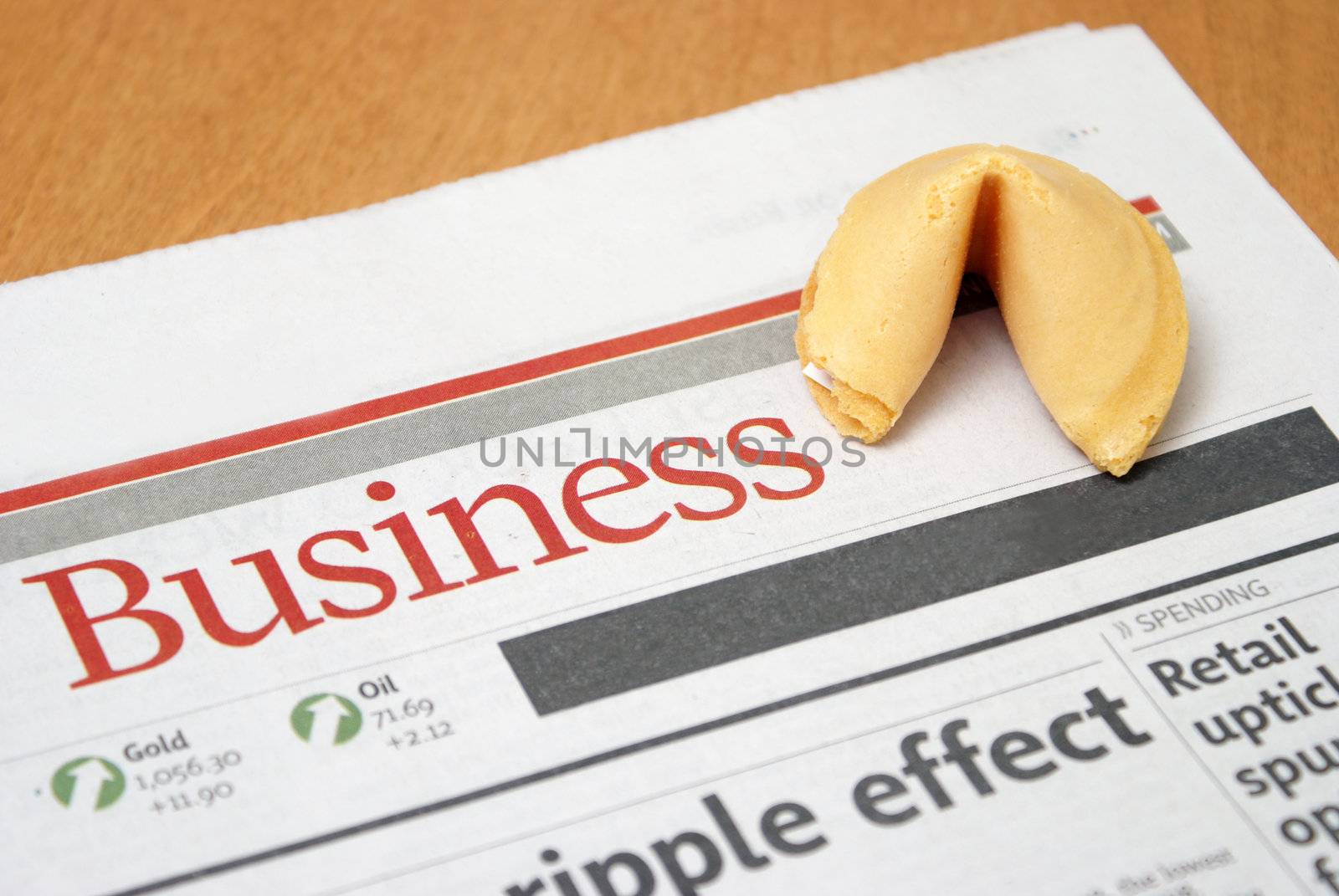 A fortune cookie on the business section of a newspaper.