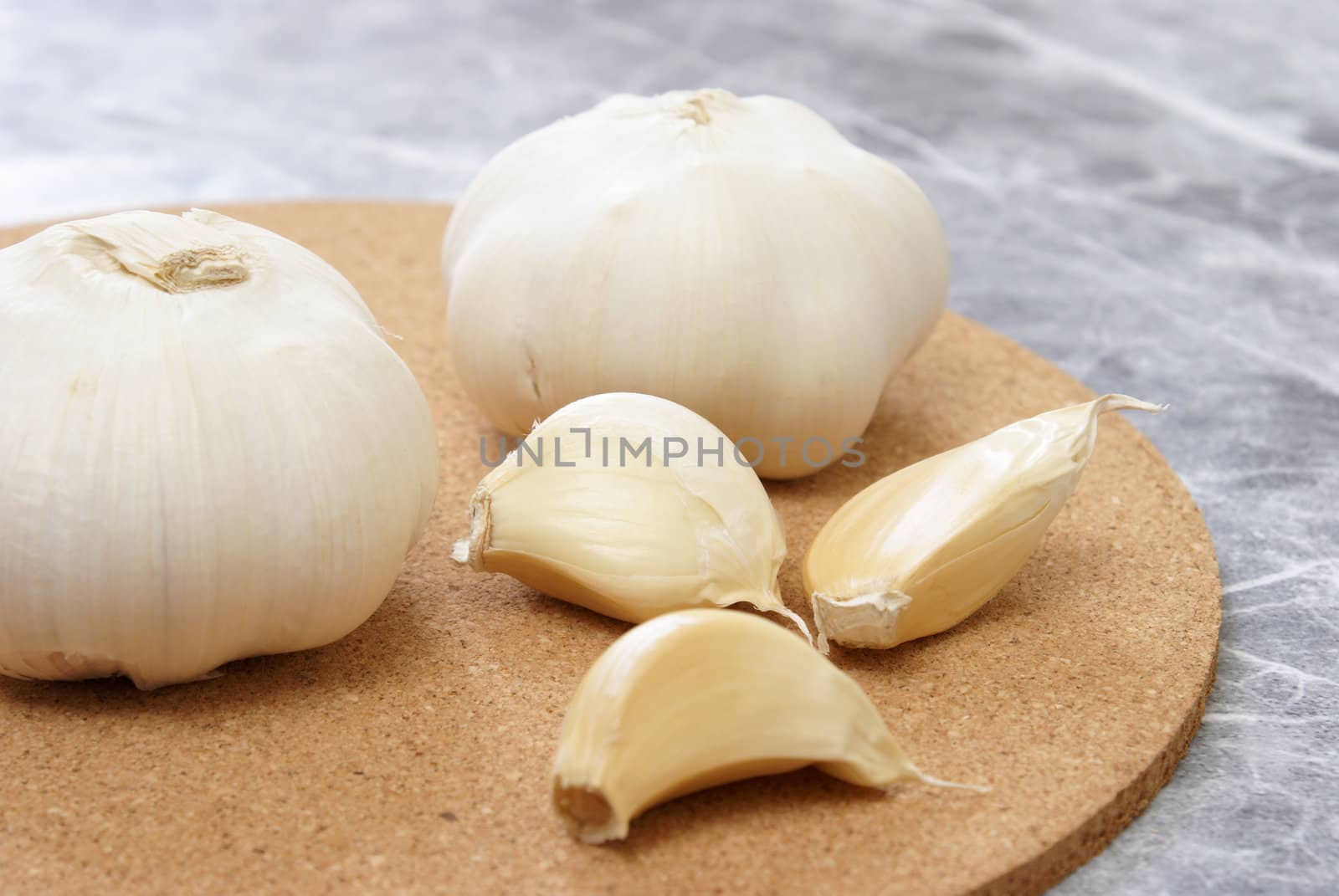 Fresh garlic is being prepared in a kitchen.
