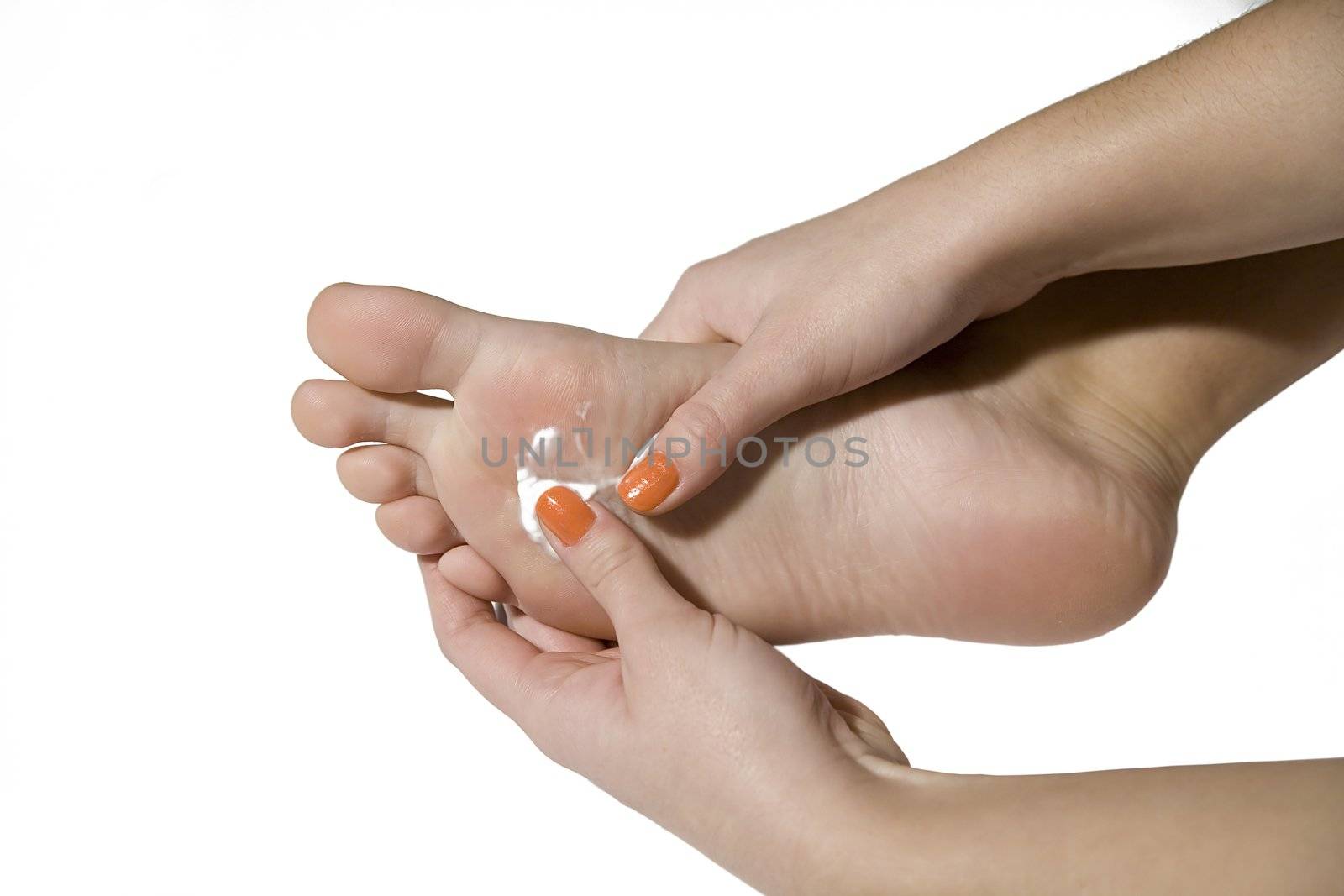 foot care with hands and cream on the white background