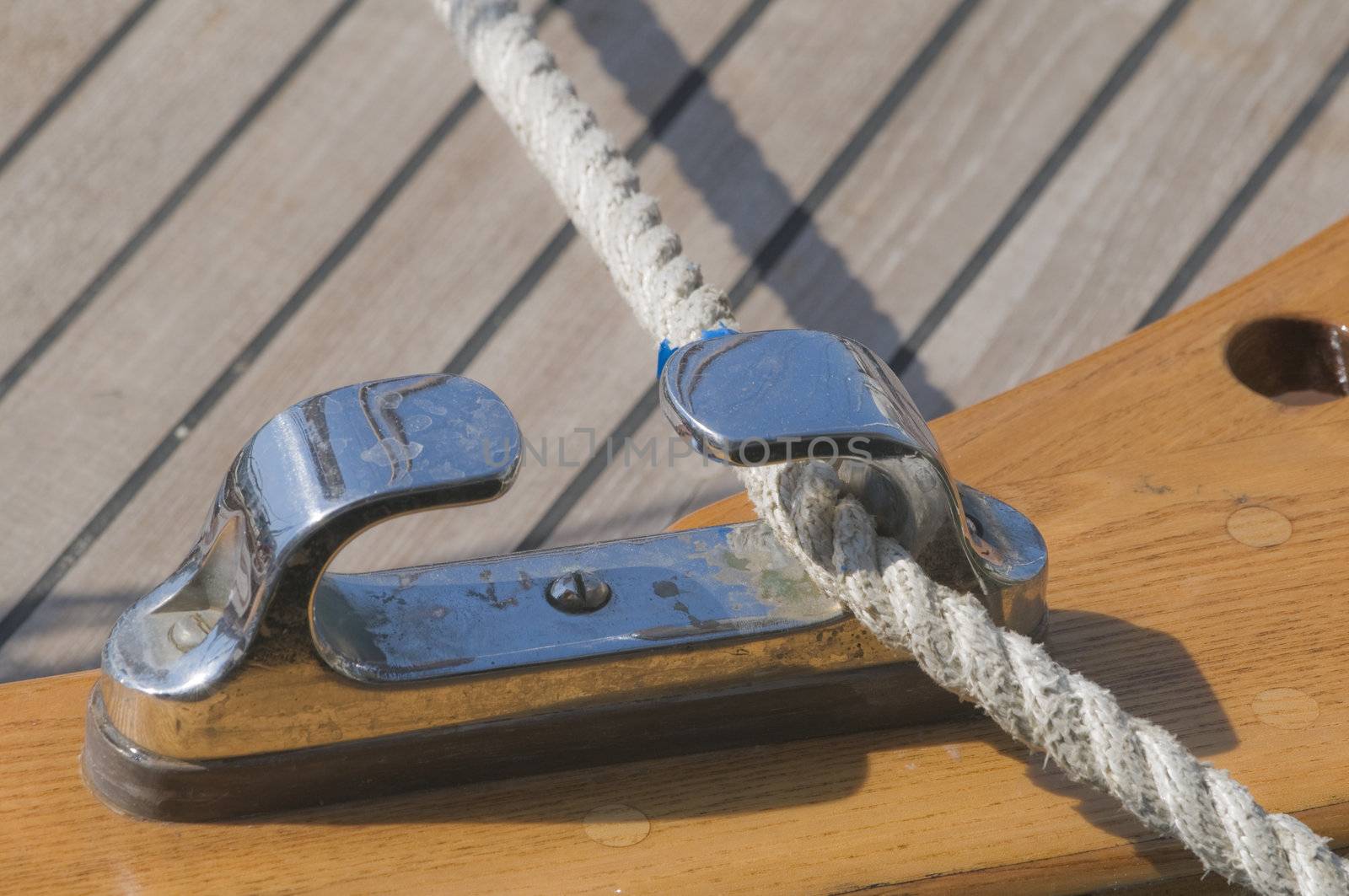 Close-up of rope fairlead on a wooden boat