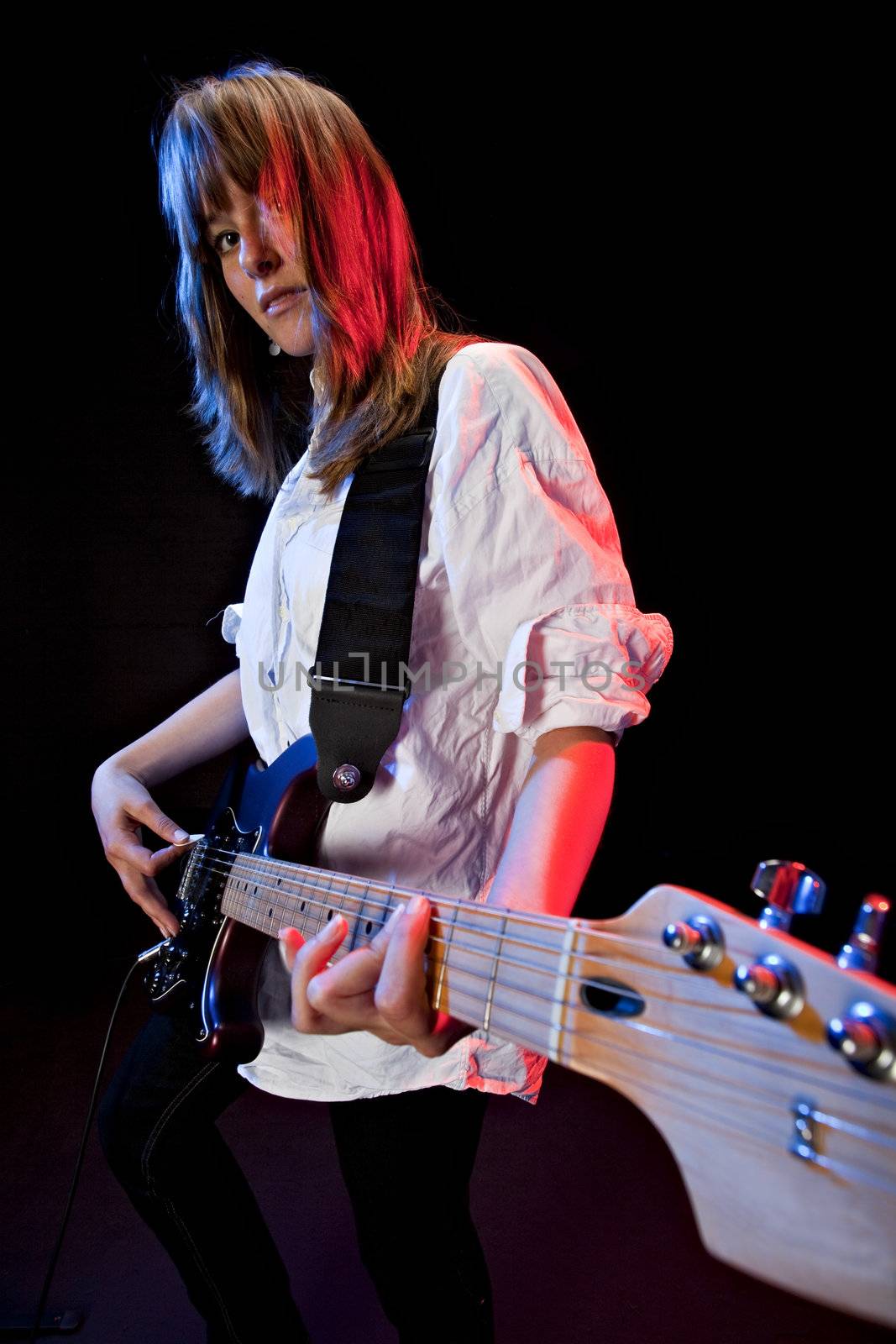 pretty young woman playing an electrical guitar by bernjuer