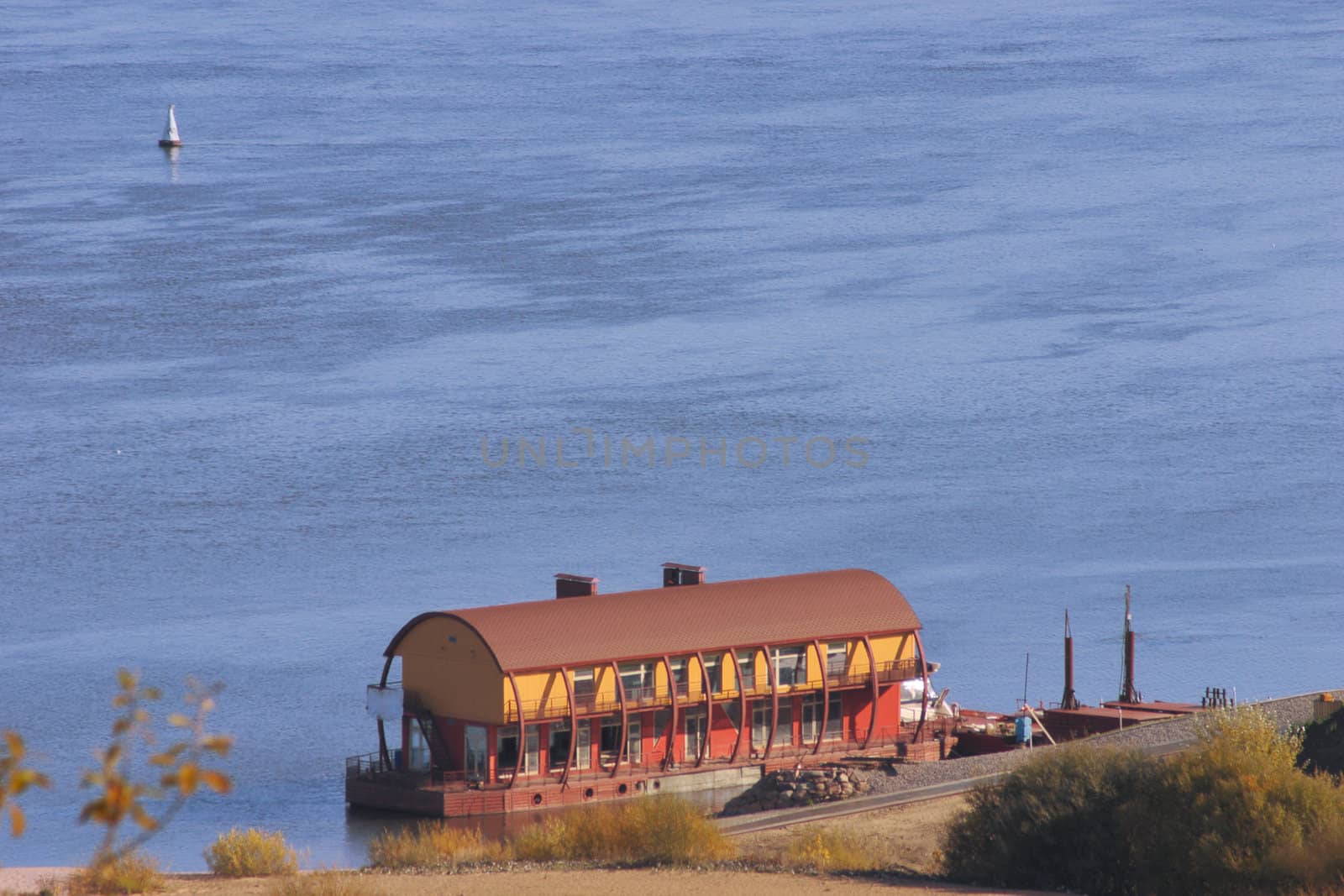 Floating boat station on the river removed in the solar autumn afternoon