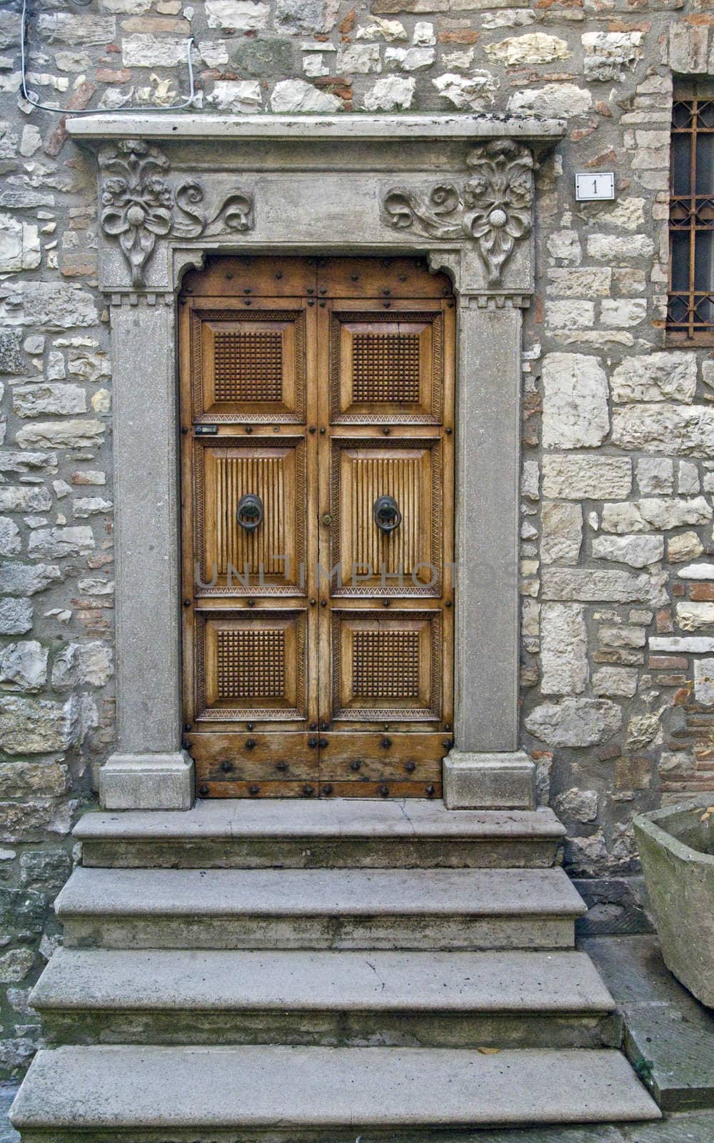 Wooden door with a stone door frame - Tuscany - Italy