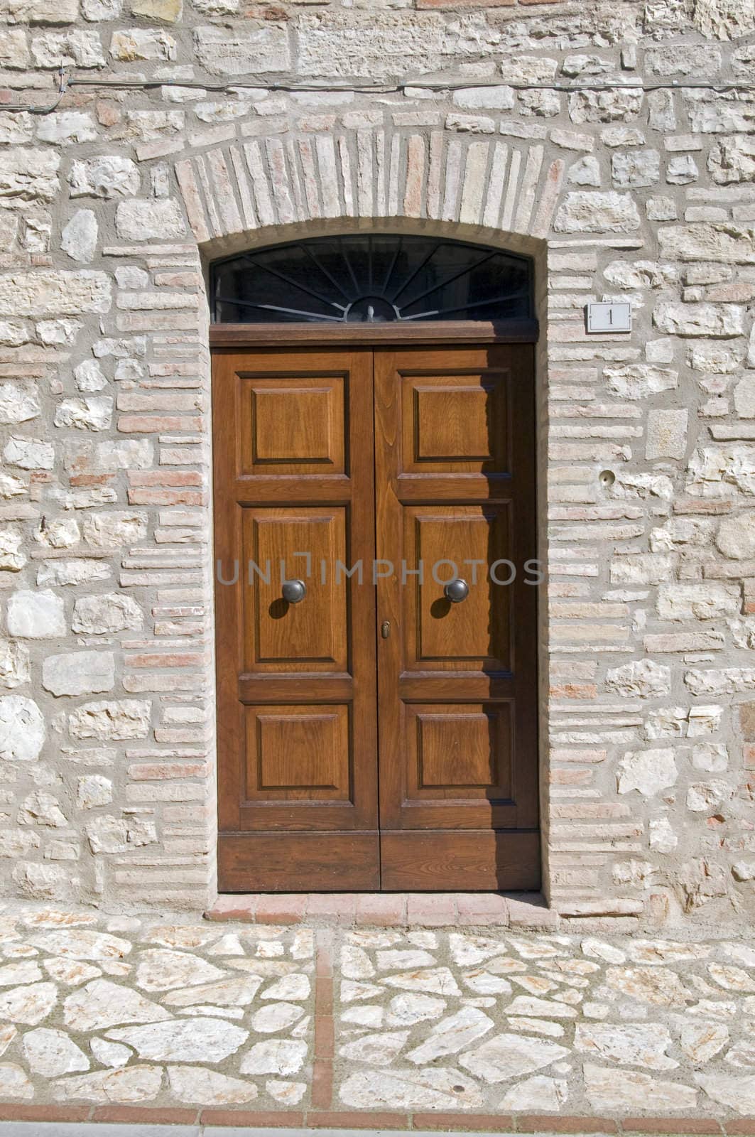 Wooden door with a stone door frame - Tuscany - Italy