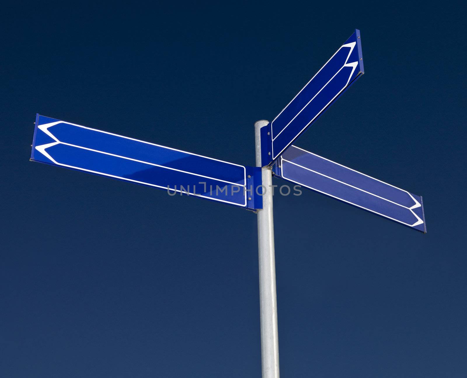 Blank signpost with six arrows against a blue background