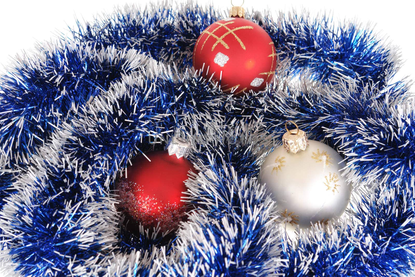 Multi-coloured Christmas-tree decorations lay on a garland                               