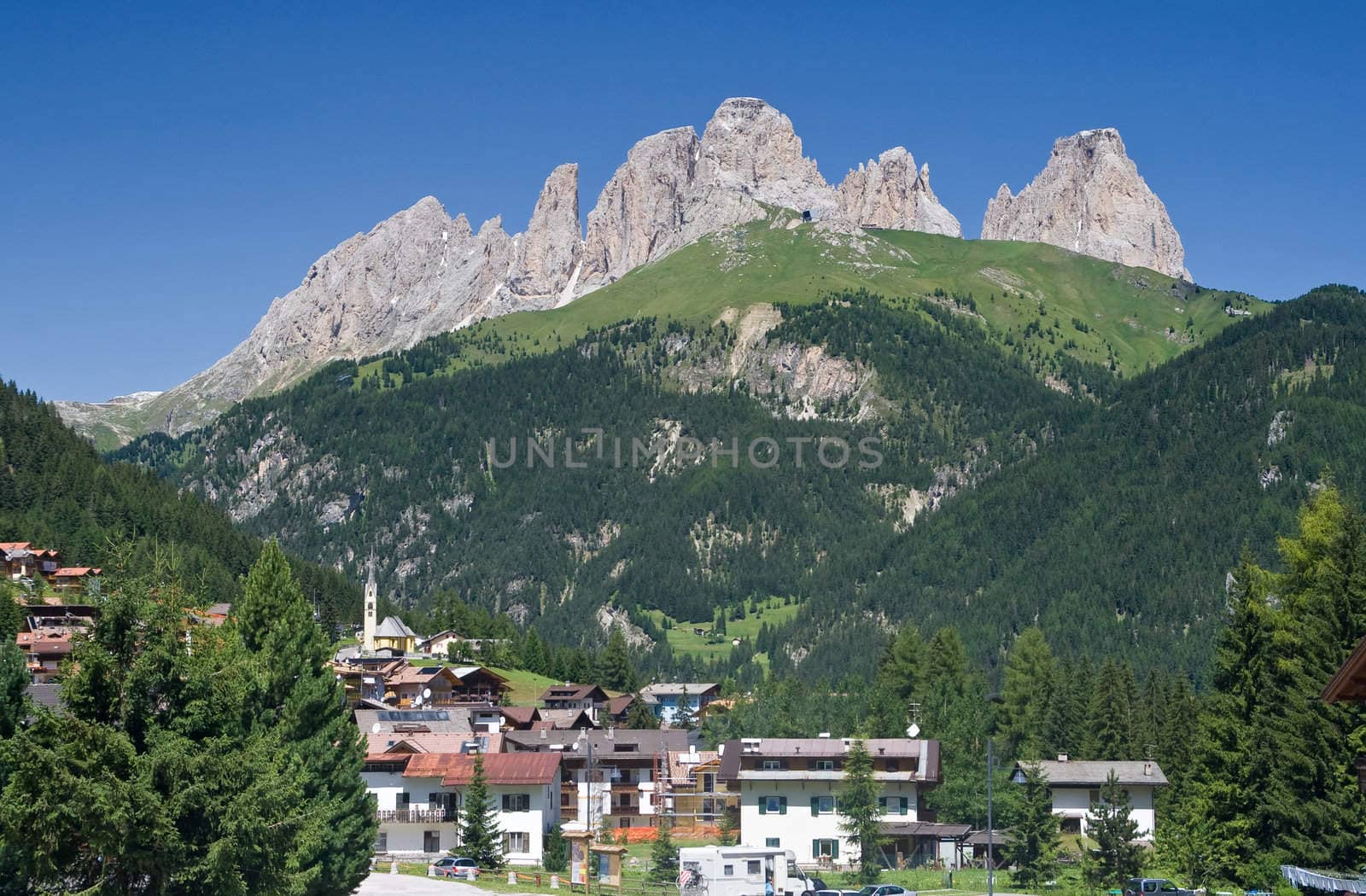 panorama of Alba di Canazei and Fassa valley with Sassolungo mount (Langkofel) behind. Photo taken with polarizer filter