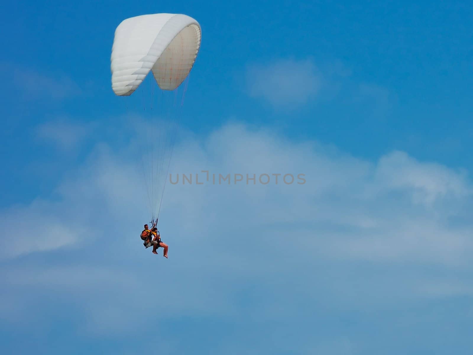 flights on a parachute by a clear summer day