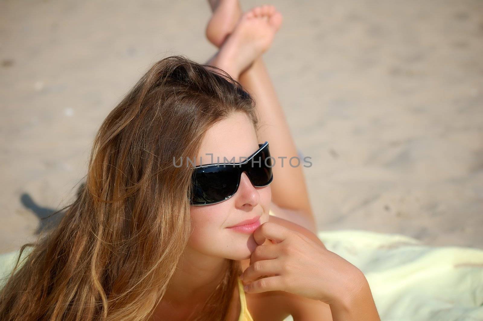 girl in a clear summer day on a marine beach