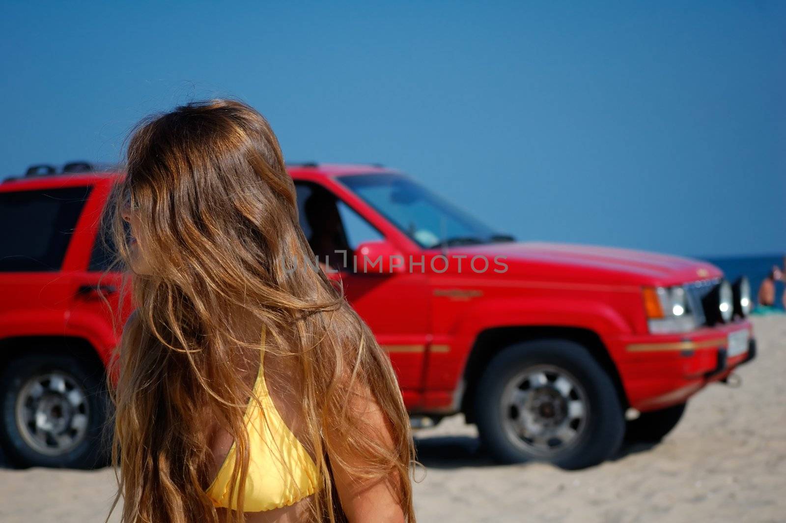 girl in a clear summer day on a marine beach