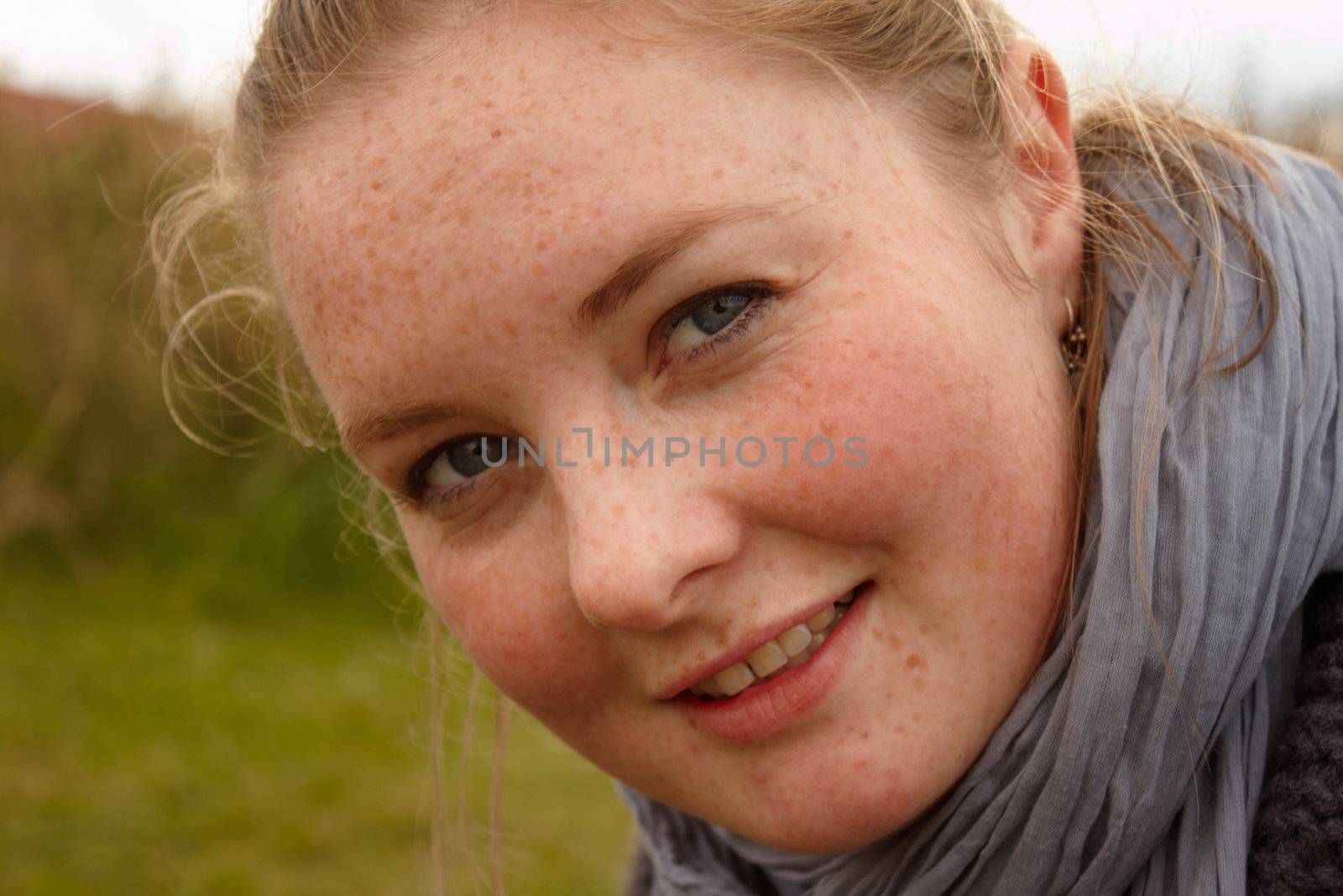 Portrait of a cute young woman looking  by FreedomImage