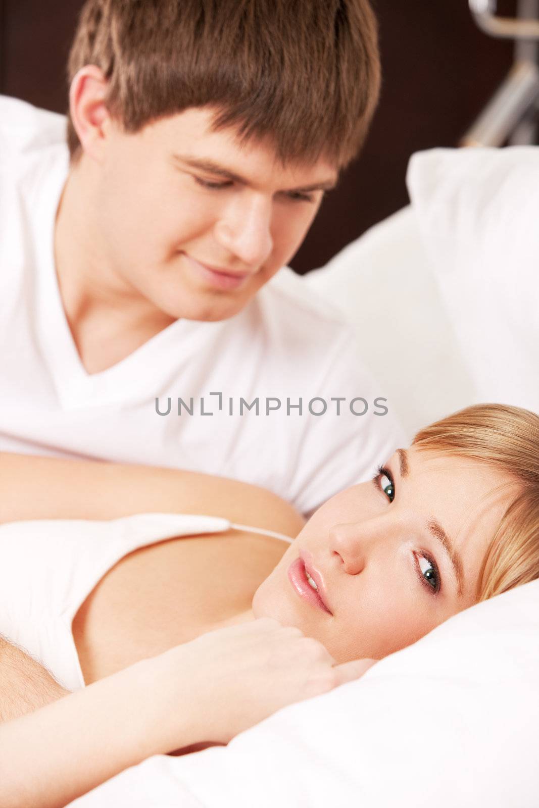 Young couple in a bed by mihhailov