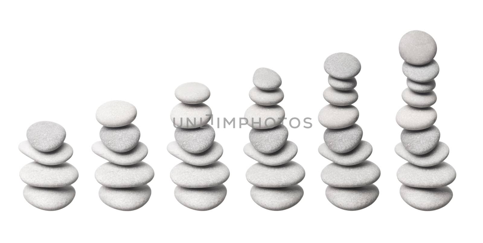 Stacked stones in progress, isolated on white background