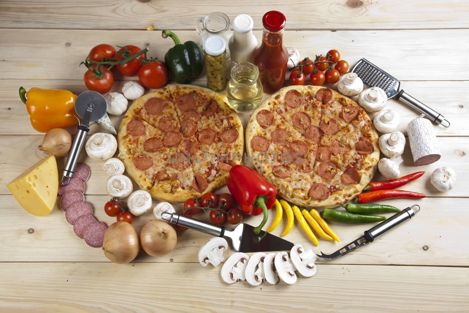 A couple of delicious pizzas, with raw tomatoes, green peppers and salami