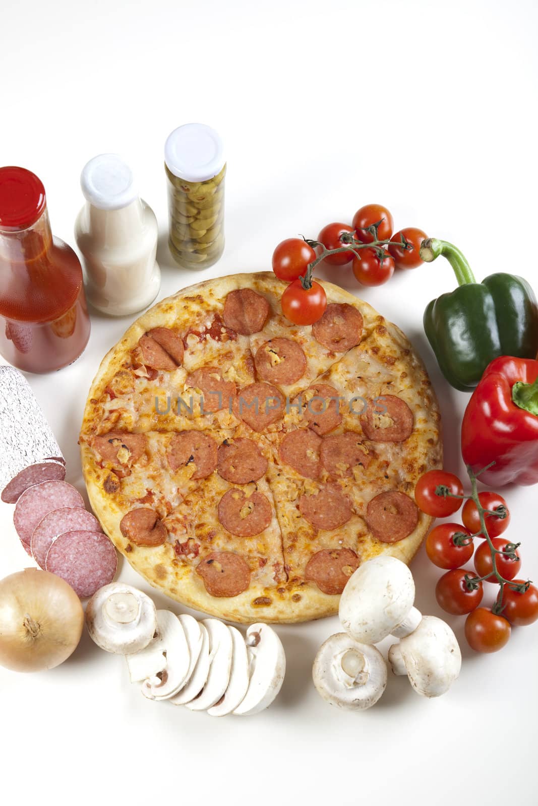 A couple of delicious pizzas, with raw tomatoes, green peppers and salami