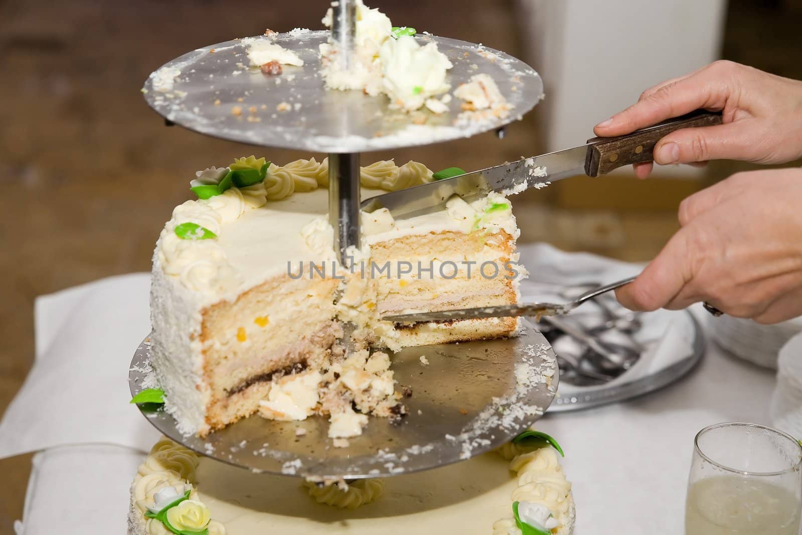 a woman cutting cake on wedding party