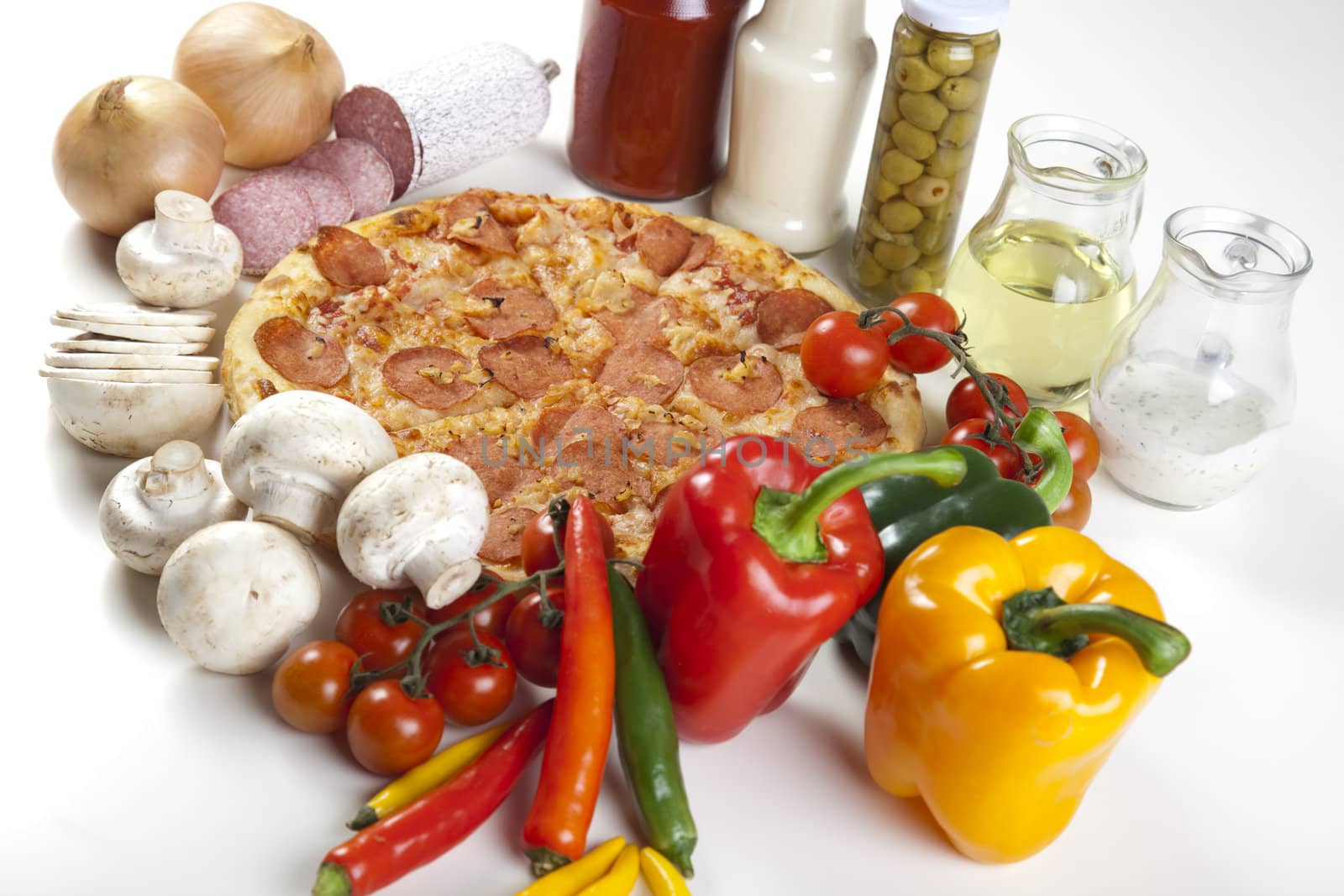 A couple of delicious pizzas, with raw tomatoes, green peppers and salami