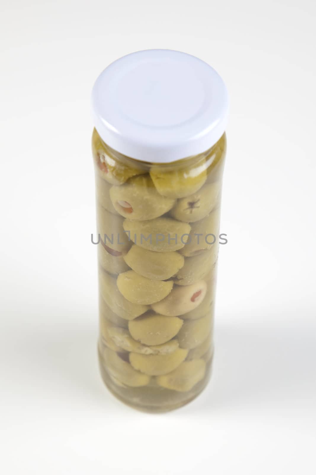 Small Olive in glass on white background