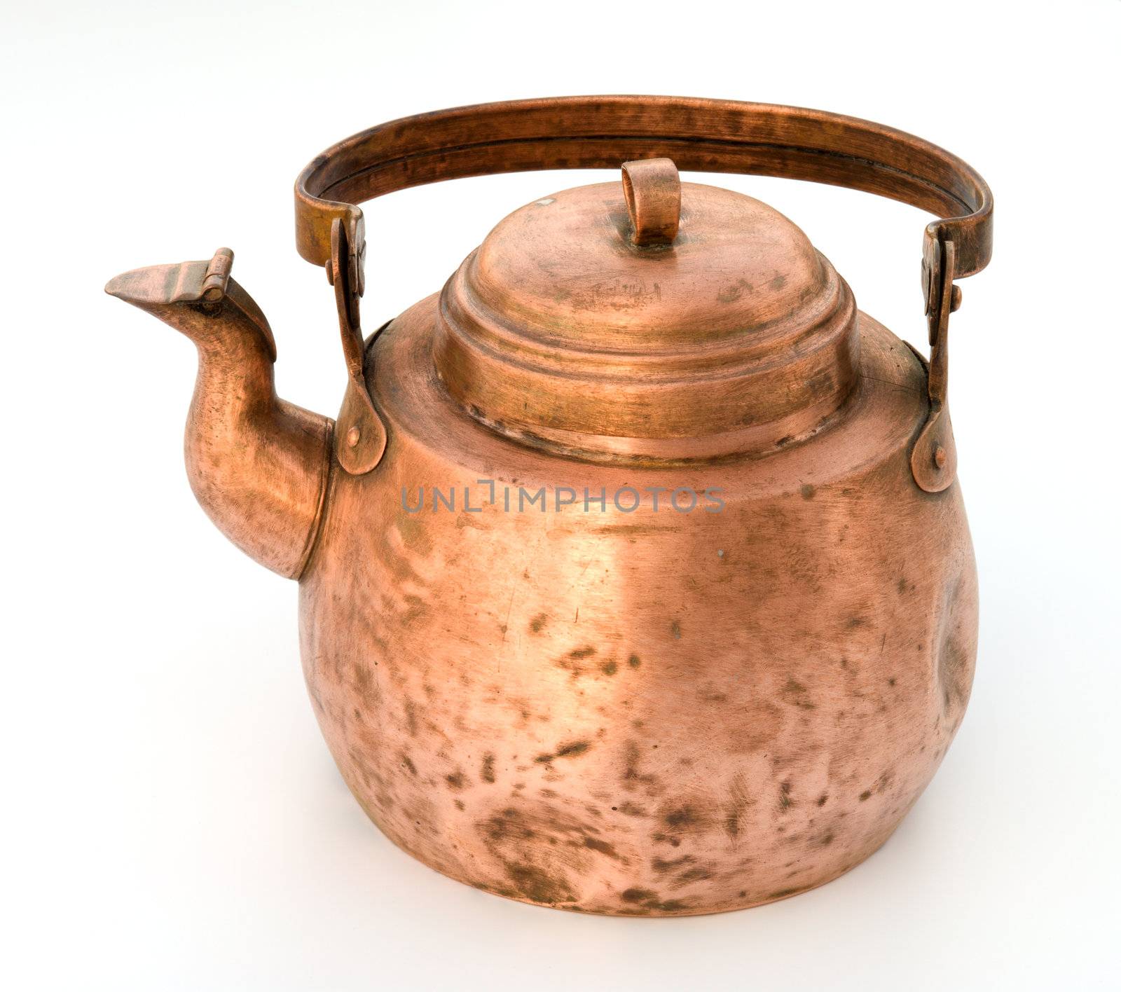 Ancient copper teapot a close up on a white background.