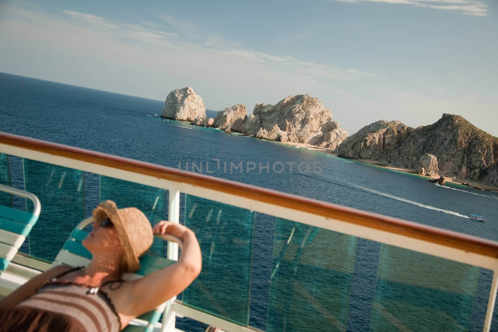 Beautiful Woman Relaxes on a Cruise Ship Deck at Land's End in Cabo San Lucas, Mexico.