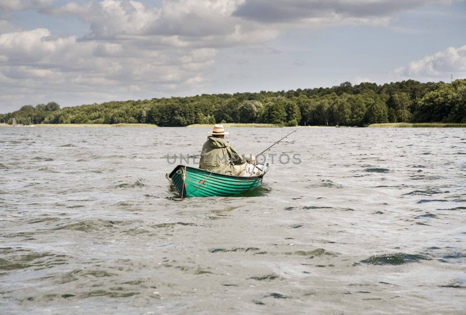 an old man fishing from the boat