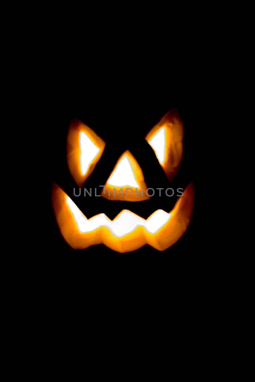 Glowing Evil Halloween Smile Isolated on a Black Background.