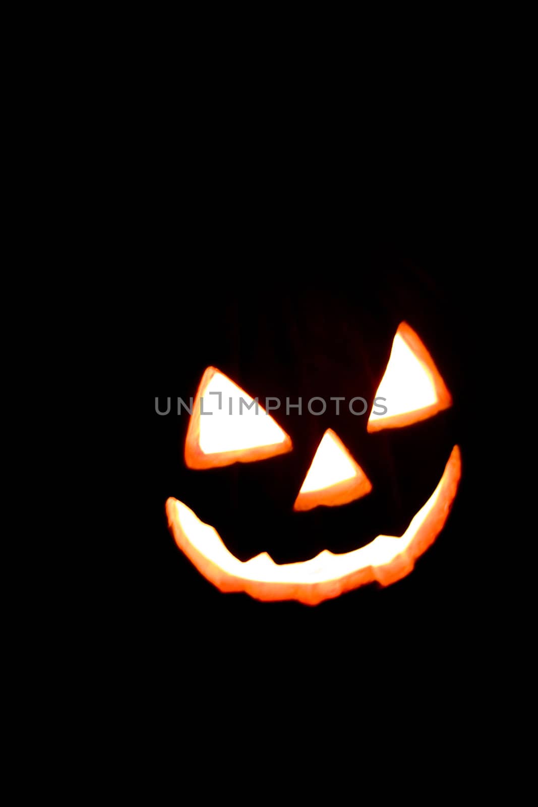 Halloween Smile Face Glowing through a Black Background