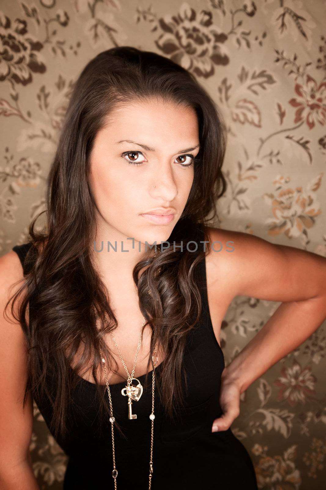 Portrait of beautiful brunette Hispanic woman in black dress