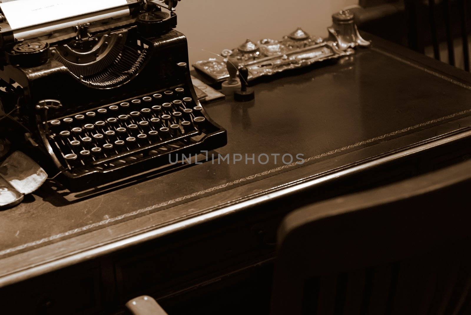 It is an old typewriter for bank on the desk.