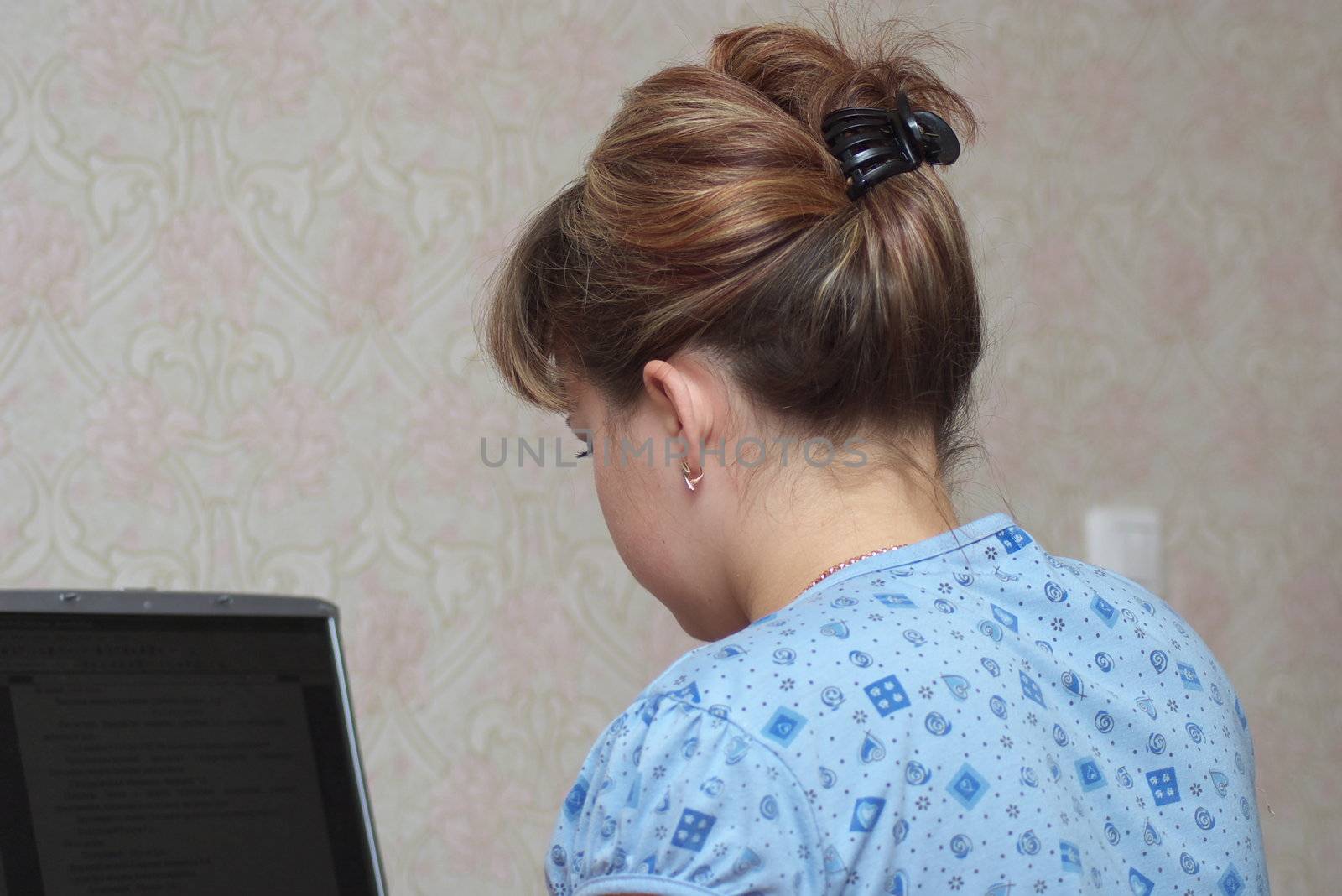 beautiful young woman works at the computer