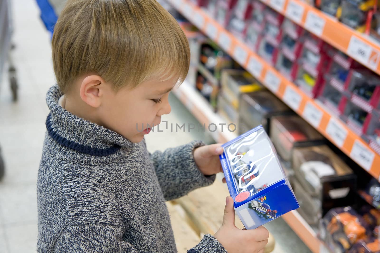 boy in shop holding toy