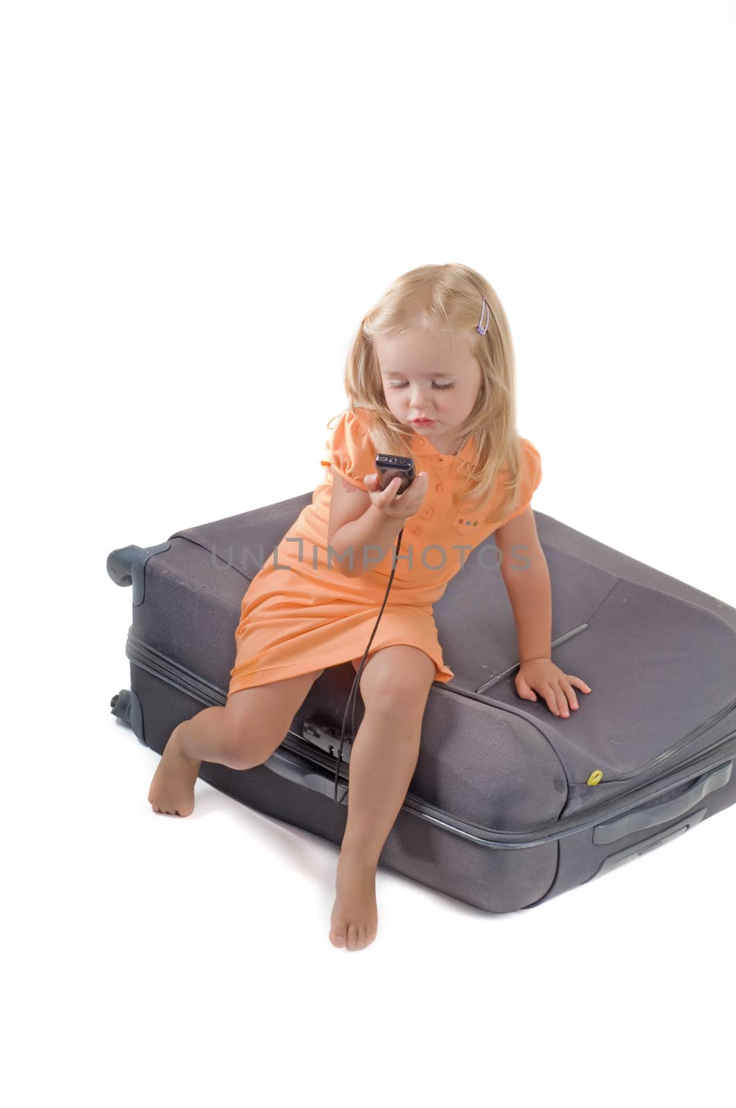Shot of little girl and suitcase in studio