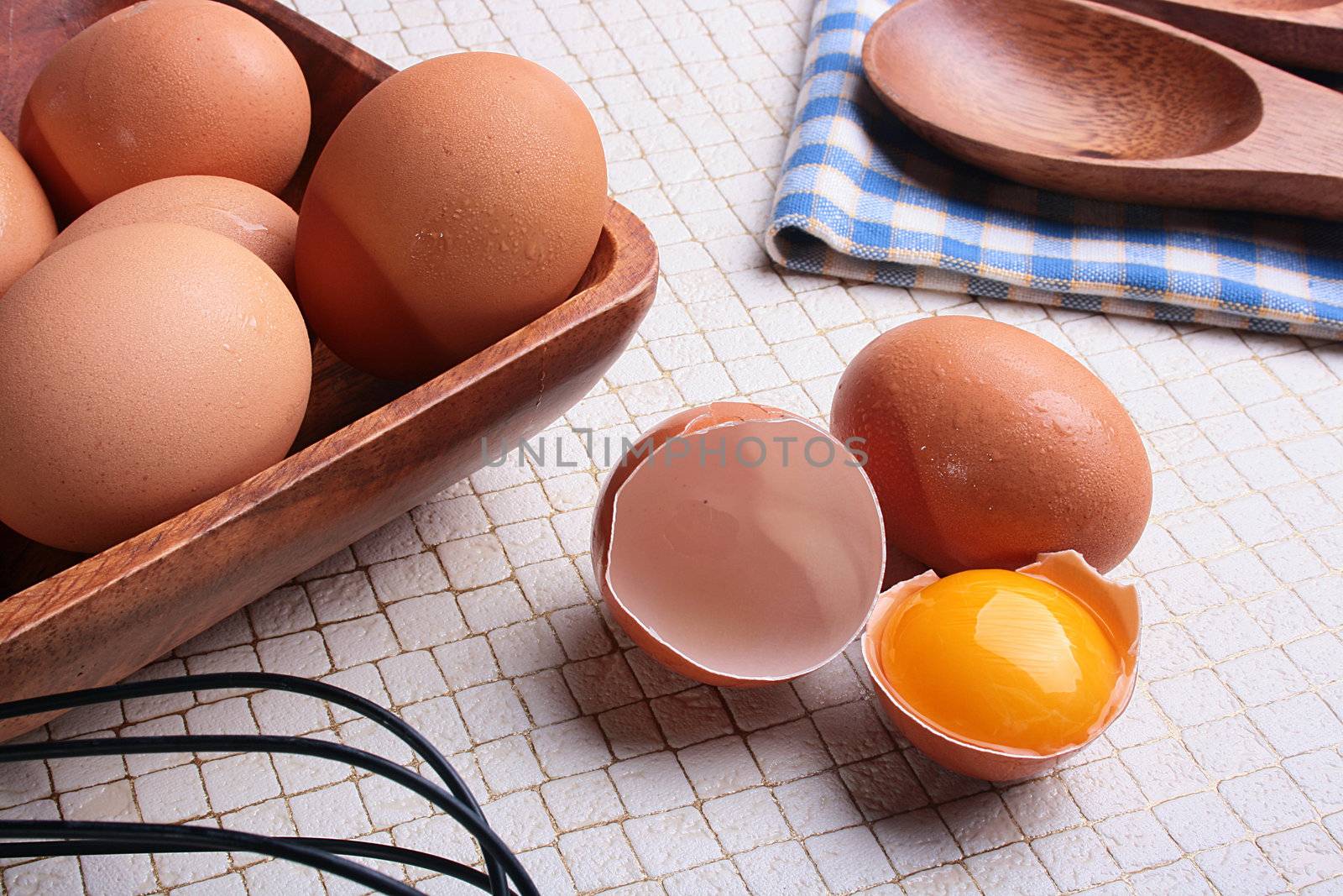 One of components of culinary recipes - the eggs, one of eggs is split and in a shell there is a yolk.