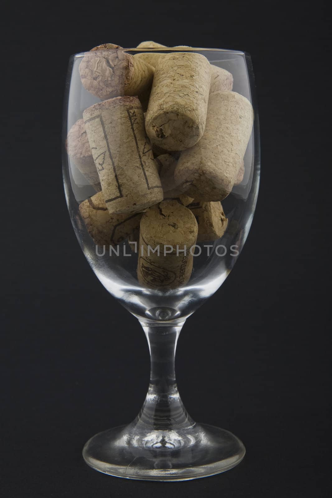 wineglass filled with corks by furzyk73